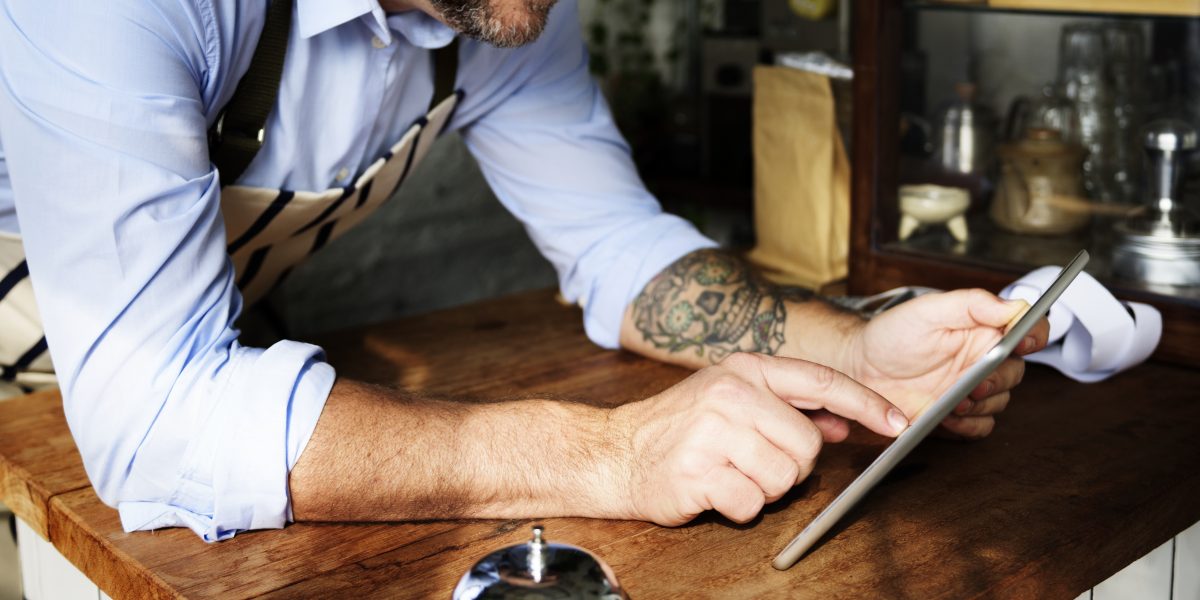 Man using digital tablet in baker's shop