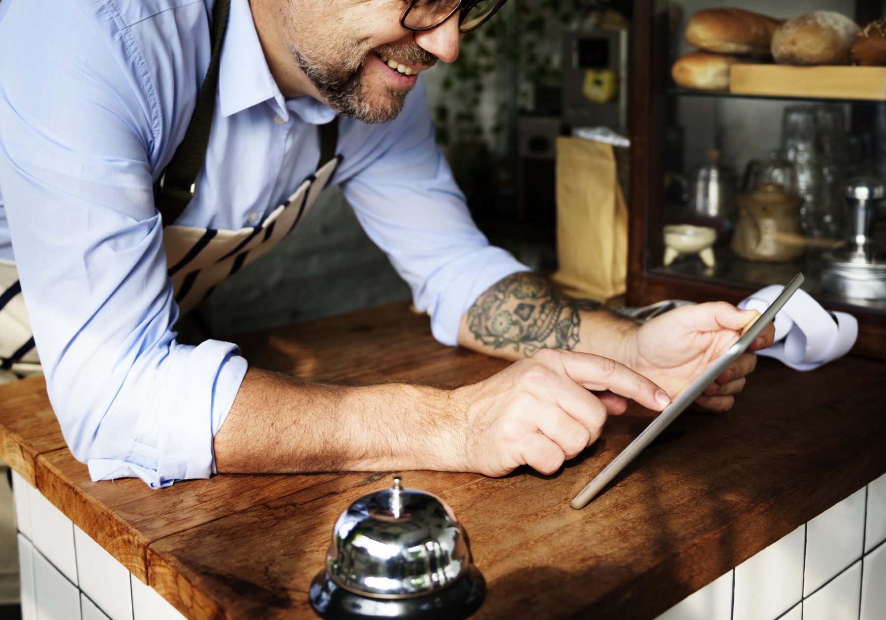 Man using digital tablet in baker's shop