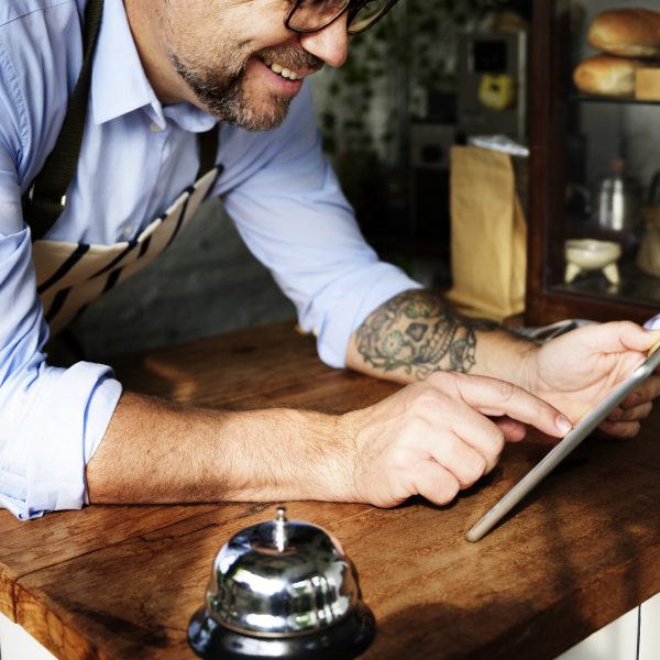 Man using digital tablet in baker's shop
